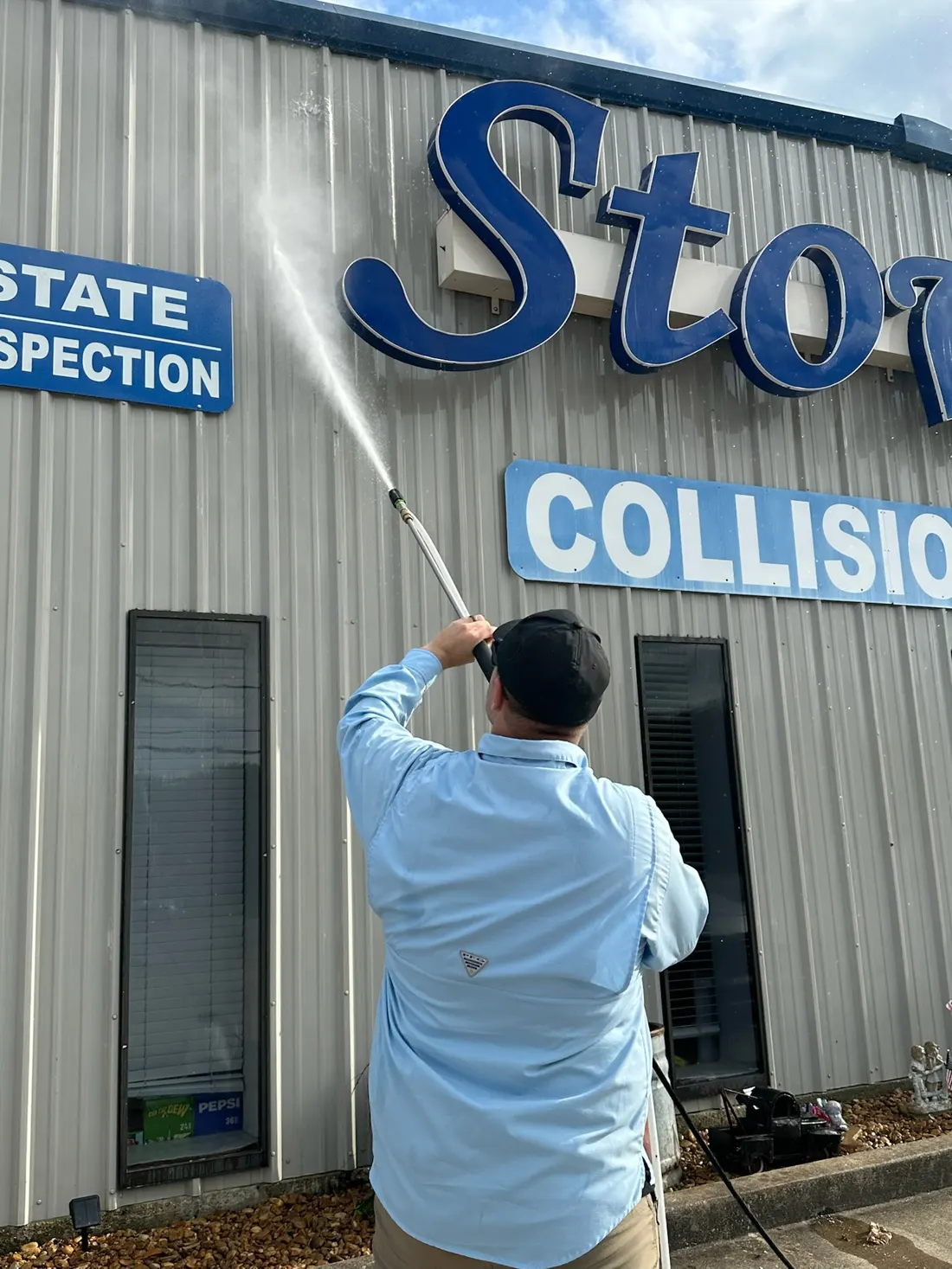Pressure washing the front of a commercial building